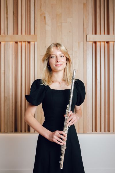 Photo of Dana holding a flute