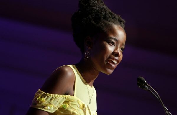 Photo of Amanda Gorman speaking in front of microphone